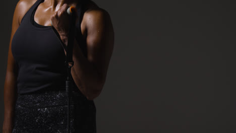 Close-Up-Studio-Shot-Of-Mature-Woman-Wearing-Gym-Fitness-Clothing-Exercising-With-Resistance-Band-2